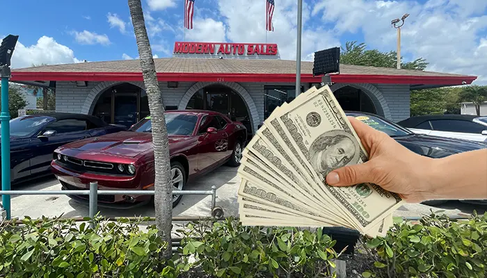Cash in hand representing tax refund savings for car buyers at Modern Auto Sales in Hollywood, FL.